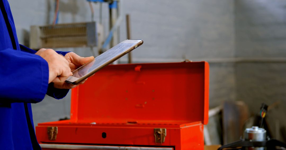 Technician Using Tablet with Open Toolbox in Workshop - Free Images, Stock Photos and Pictures on Pikwizard.com