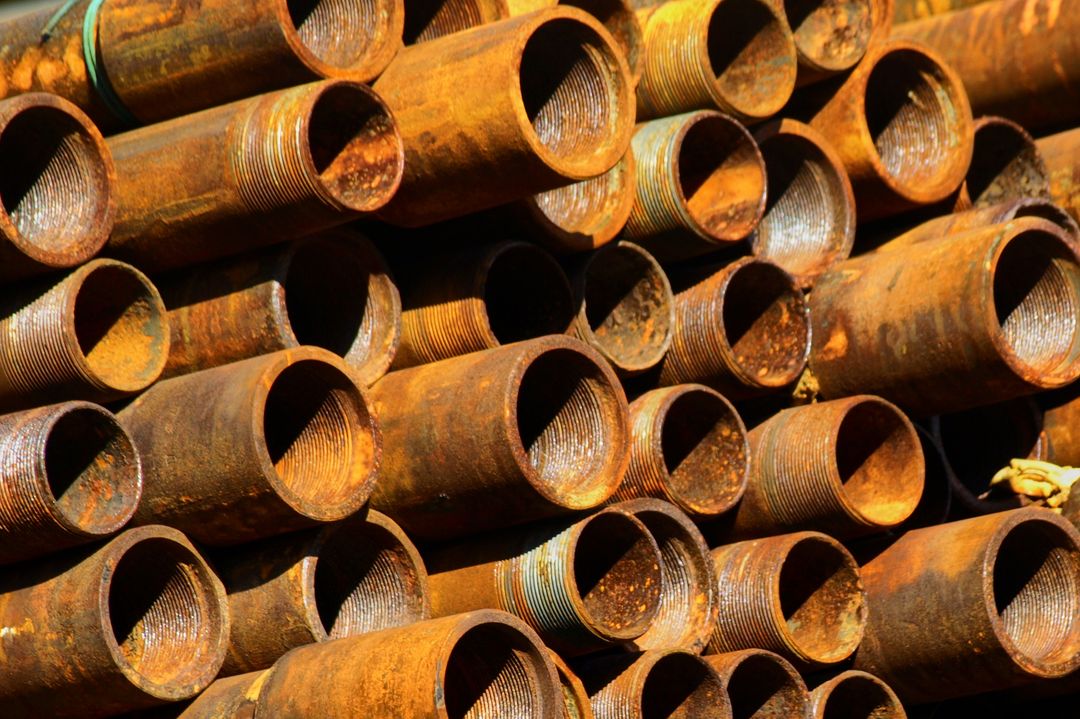 Stack of Weathered Rusty Industrial Pipes