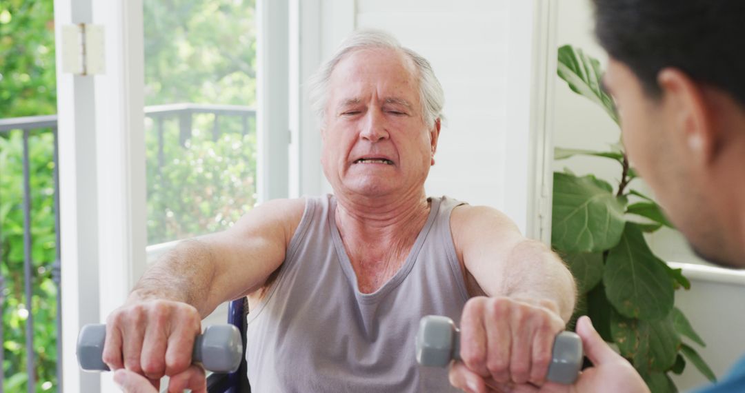 Senior Man Exercising with Dumbbells in Rehabilitation Therapy - Free Images, Stock Photos and Pictures on Pikwizard.com