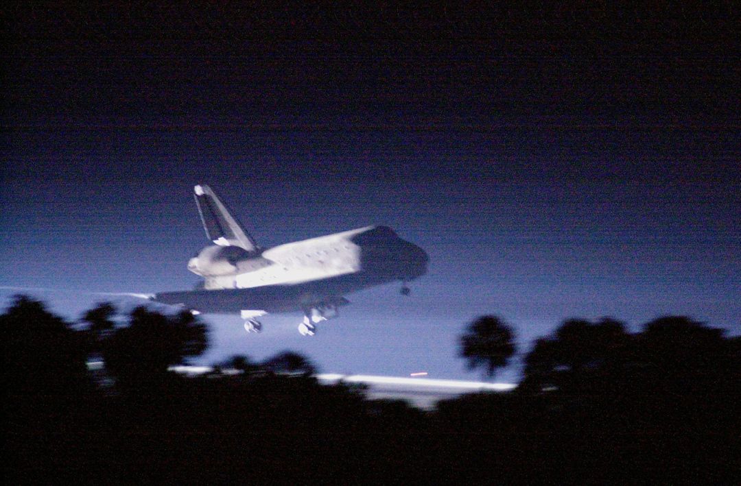 Space Shuttle Atlantis Illuminated During Nighttime Landing at Kennedy Space Center - Free Images, Stock Photos and Pictures on Pikwizard.com