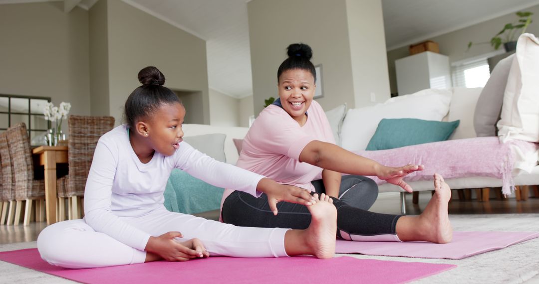 Mother and Daughter Stretching Together During Home Workout - Free Images, Stock Photos and Pictures on Pikwizard.com