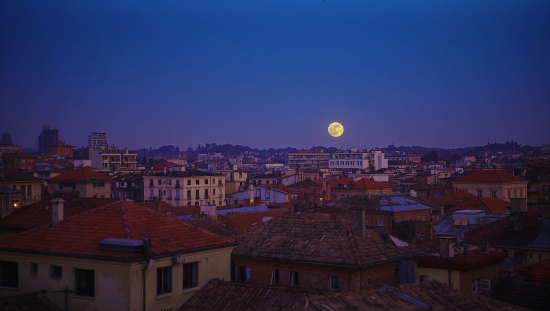 Full Moon Over City Skyline at Dusk with Tiled Roofs