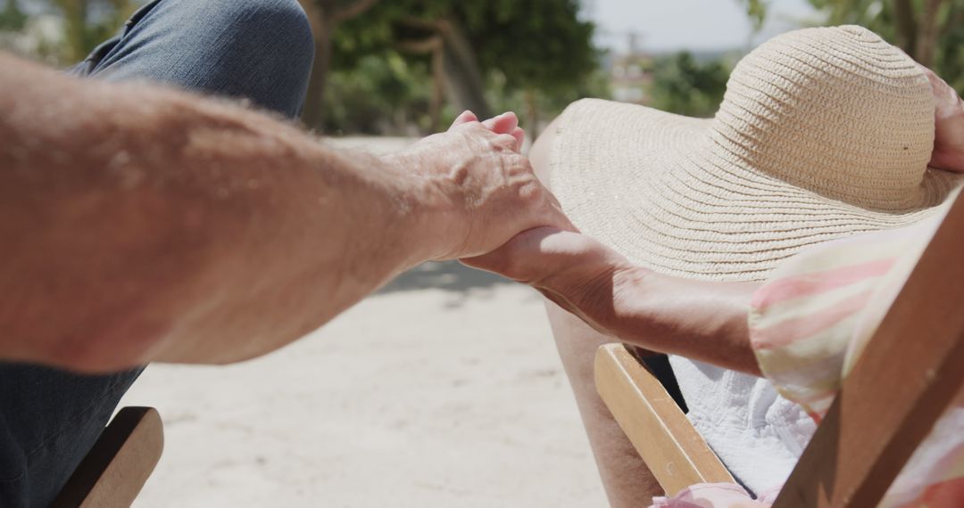 Couple Relaxing and Holding Hands on Beach - Free Images, Stock Photos and Pictures on Pikwizard.com