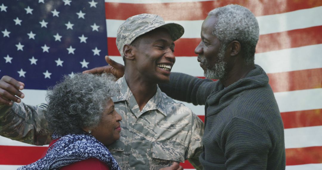 Smiling African American Soldier Embracing Family in Front of American Flag - Free Images, Stock Photos and Pictures on Pikwizard.com