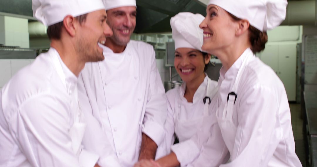 Group of Happy Chefs Enjoying a Nice Conversation in Professional Kitchen - Free Images, Stock Photos and Pictures on Pikwizard.com