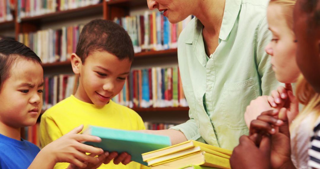 Teacher Encouraging Group of Children in Library