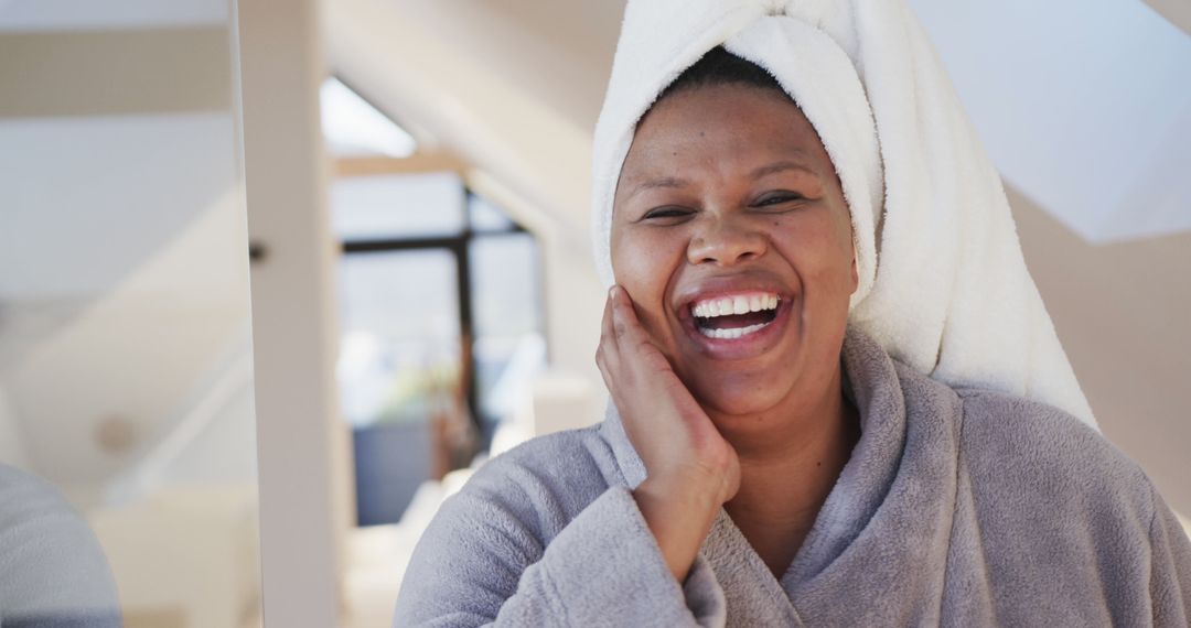 Happy Woman with Towel on Her Head Laughing - Free Images, Stock Photos and Pictures on Pikwizard.com