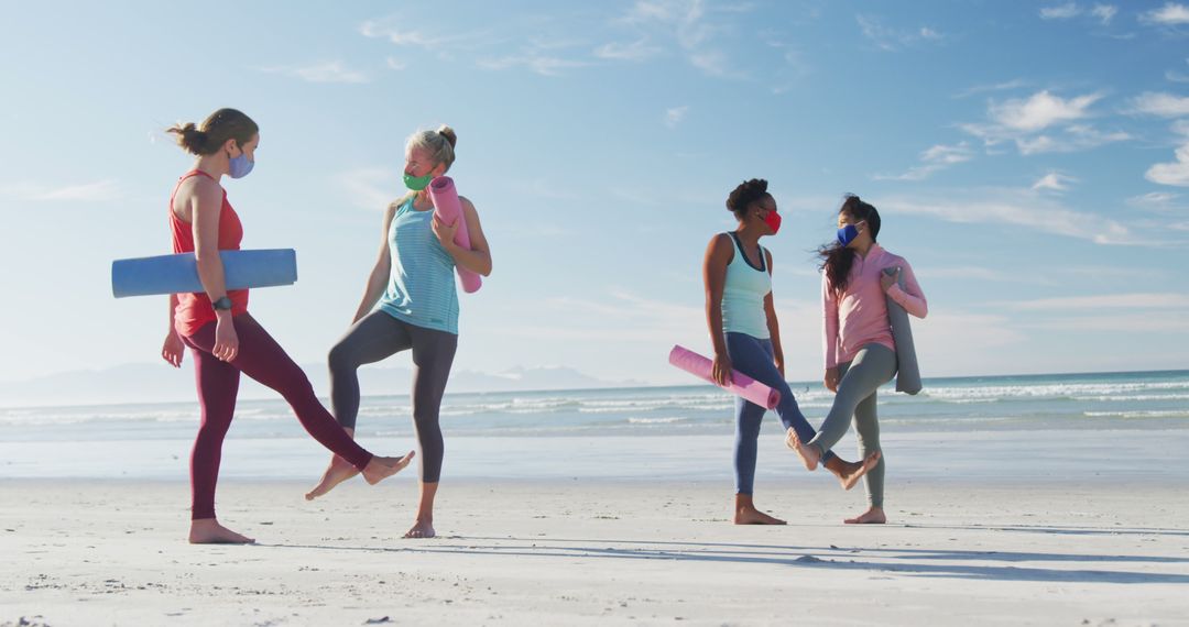 Women Practicing Yoga Together on Beach Wearing Masks - Free Images, Stock Photos and Pictures on Pikwizard.com