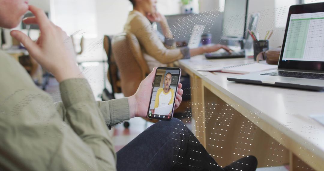 Modern Office: Hand Holding Smartphone in Team Workspace