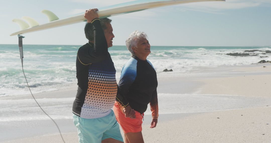 Senior Couple Enjoying Beach Walk with Surfboard