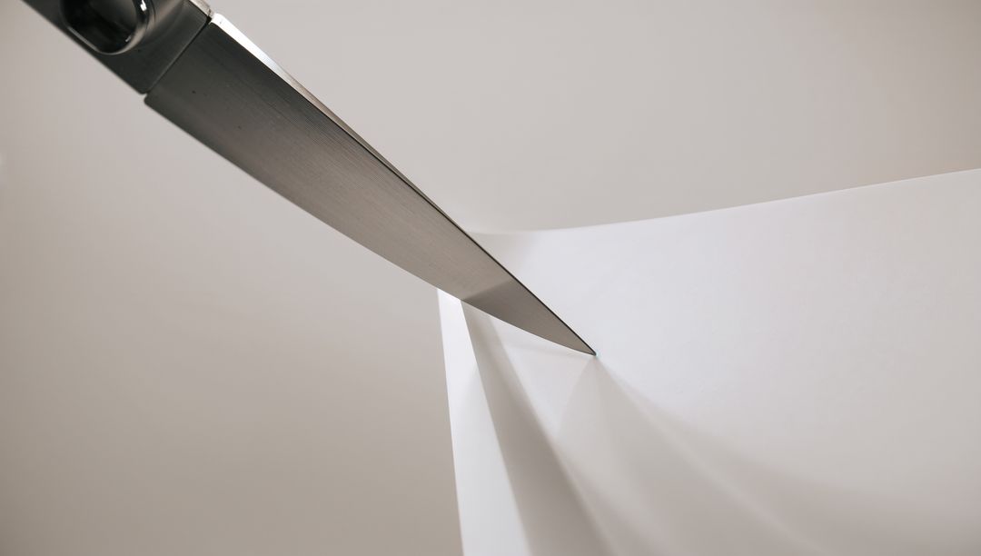 Stainless-steel Knife Slicing Folded White Paper Casting Sharp Shadow