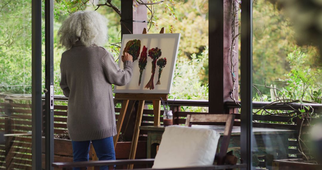 Senior Woman Painting Botanicals On Enclosed Porch - Free Images, Stock Photos and Pictures on Pikwizard.com