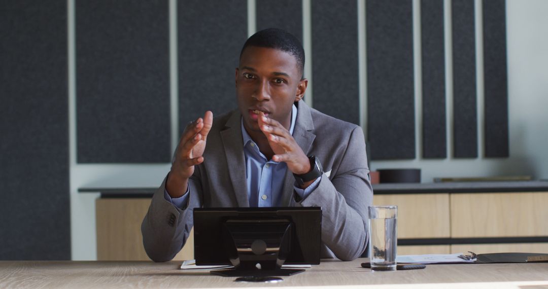 Businessman Discussing Strategy at Office Desk with Tablet - Free Images, Stock Photos and Pictures on Pikwizard.com