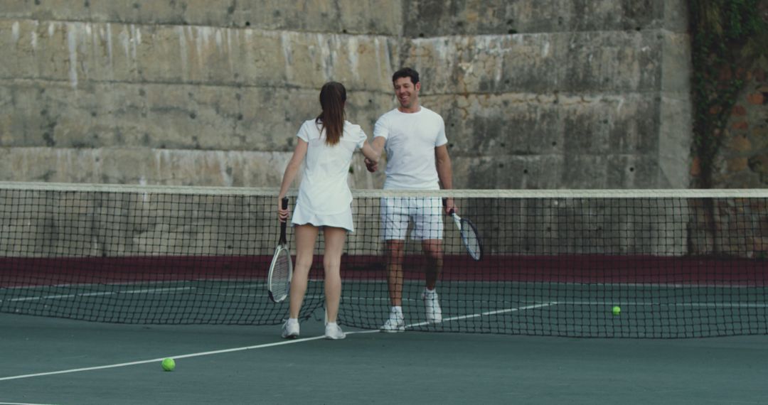 Man and Woman Shaking Hands on Tennis Court After Match - Free Images, Stock Photos and Pictures on Pikwizard.com