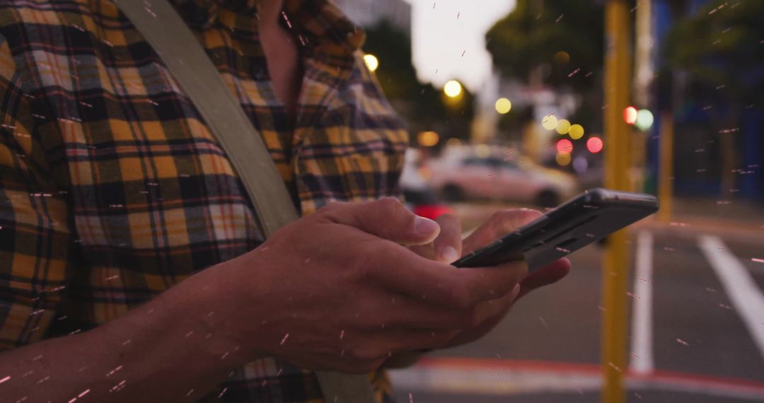 Urban Man Using Smartphone in Evening Cityscape