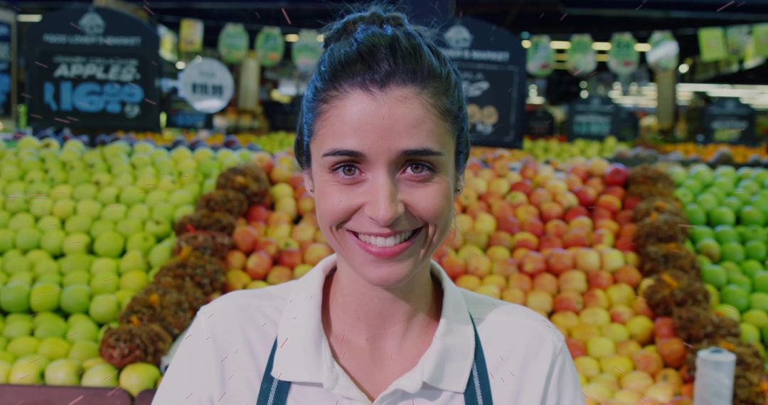 Smiling Store Clerk Organizing Apples in Market Produce Aisle