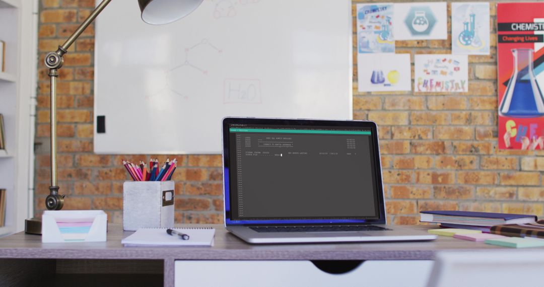 Laptop on Office Desk with Programming Interface