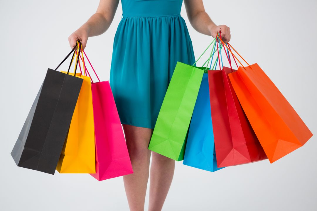 Woman Holding Colorful Shopping Bags Against White Background - Free Images, Stock Photos and Pictures on Pikwizard.com