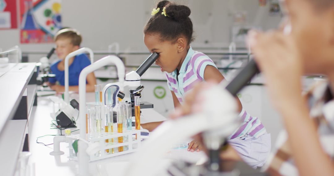 Image of happy african american girl with microscope during lesson - Free Images, Stock Photos and Pictures on Pikwizard.com