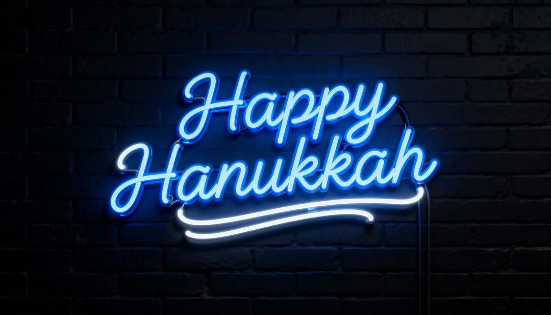 Glowing Blue Neon Happy Hanukkah Script Sign with White Swash on Dark Brick Wall