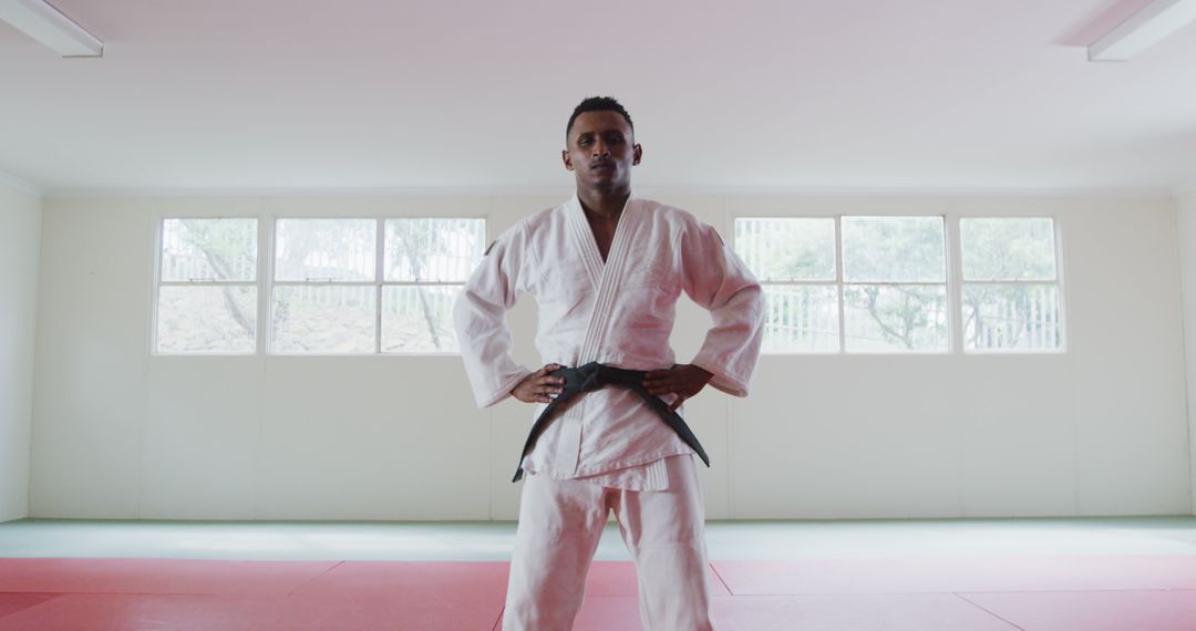 Confident Male Martial Artist in Judo Gi Standing in Training Dojo - Free Images, Stock Photos and Pictures on Pikwizard.com