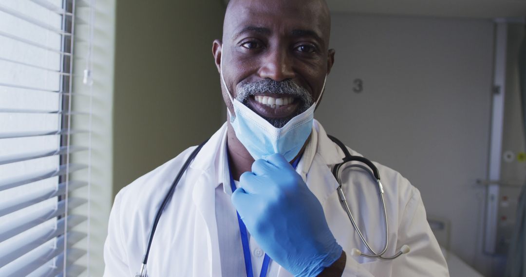 African American Doctor Adjusting Face Mask in Hospital - Free Images, Stock Photos and Pictures on Pikwizard.com