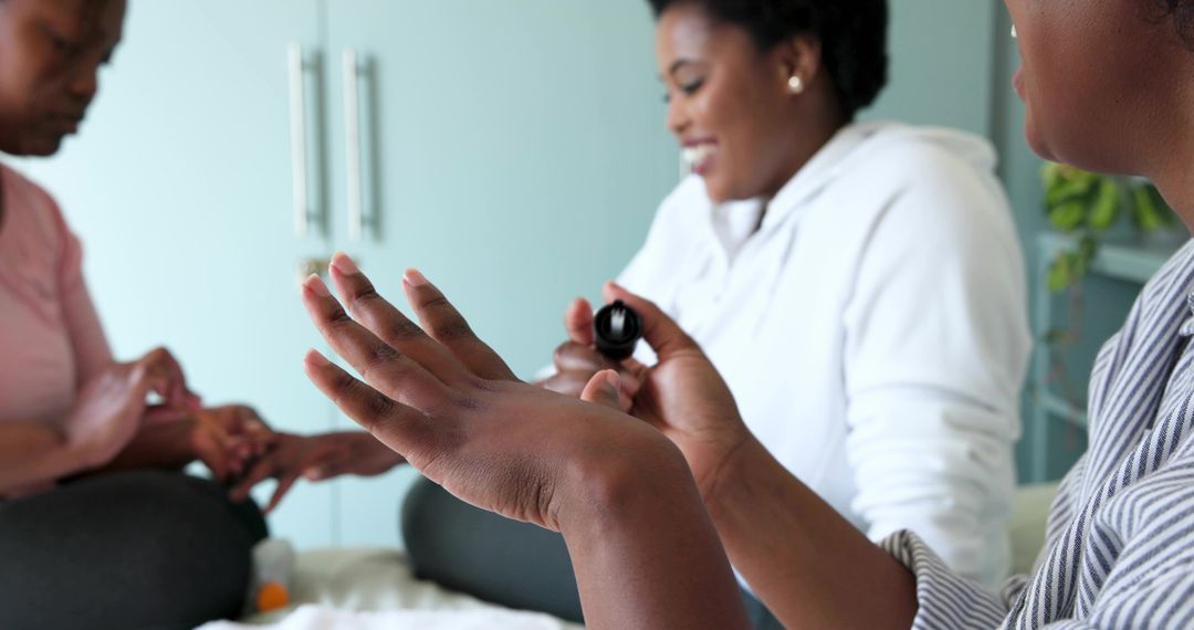 Friends Painting Nails at Home Bonding Over Manicure and Self Care in Pastel Room