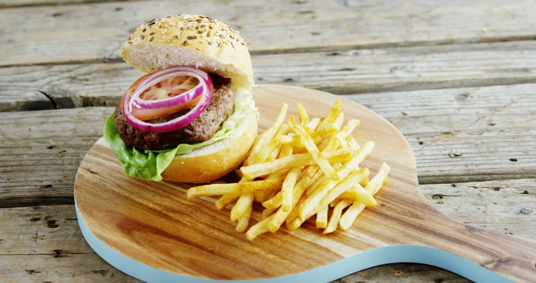 Delicious Burger with Fries on Wooden Board - Free Images, Stock Photos and Pictures on Pikwizard.com