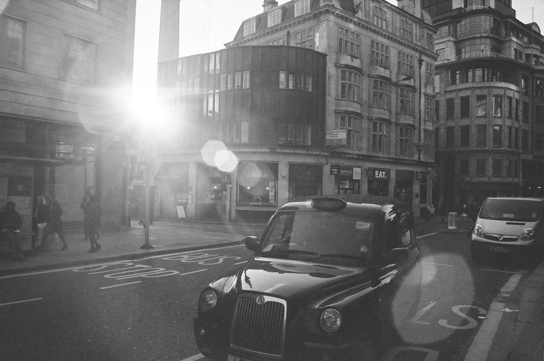 Black Taxi in Bustling City Street with Flare - Free Images, Stock Photos and Pictures on Pikwizard.com