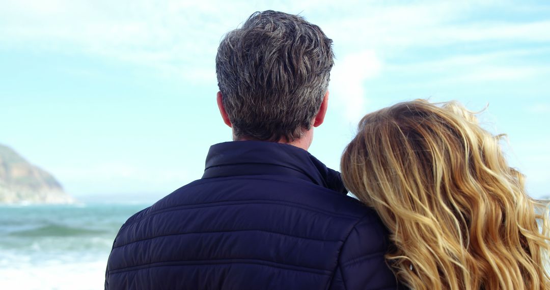 Couple Embracing While Looking at Ocean with Mountain in Distance - Free Images, Stock Photos and Pictures on Pikwizard.com