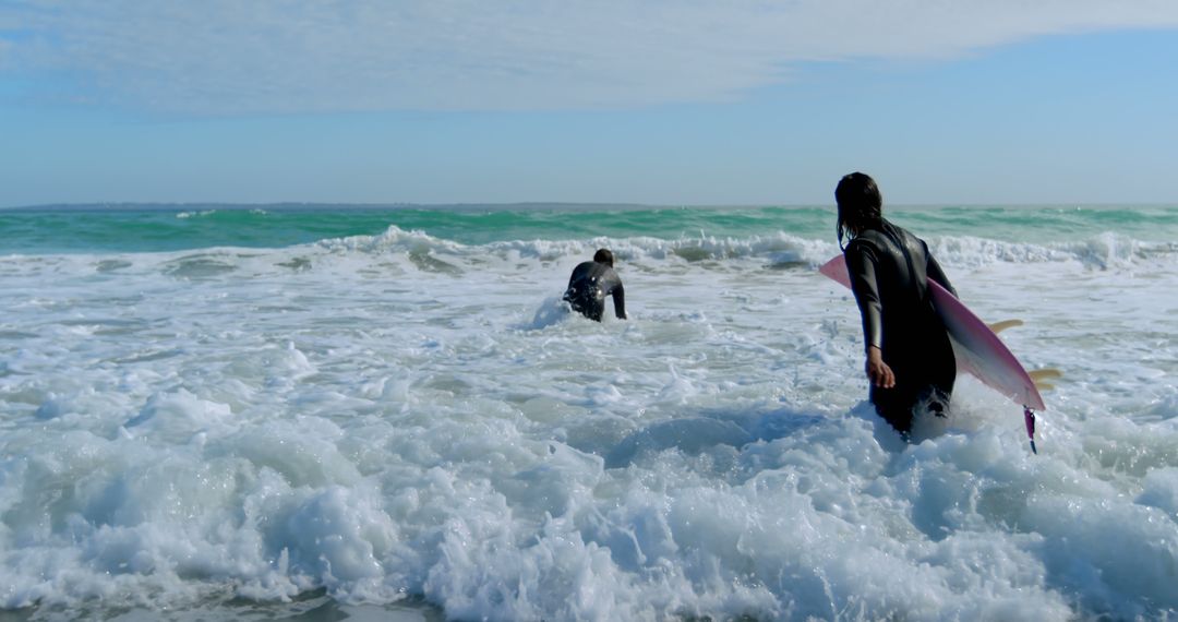 Surfers Embracing Adventure in Ocean Waves - Free Images, Stock Photos and Pictures on Pikwizard.com