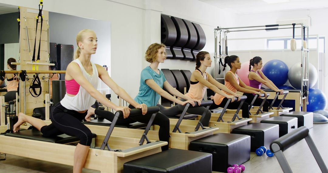 Women Practicing Pilates in Fitness Class using Reformers - Free Images, Stock Photos and Pictures on Pikwizard.com