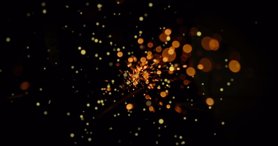 Flickering Embers and Glowing Sparks in Dark Atmosphere