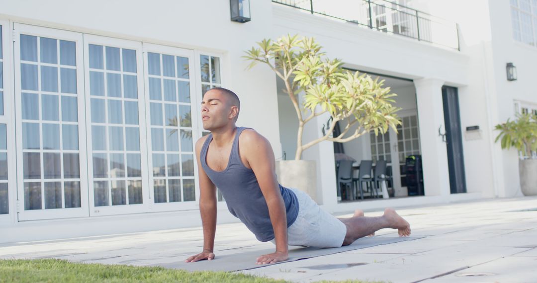 Man Practicing Yoga Outdoors Upscale Home Background - Free Images, Stock Photos and Pictures on Pikwizard.com