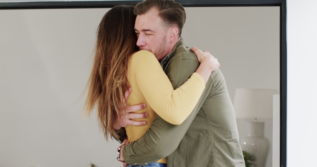 Joyful Reunion of Couple Hugging Enthusiastically