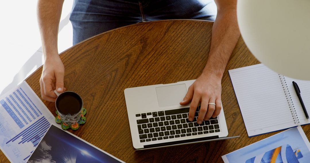 Caucasian Man Working Productively on Laptop at Desk