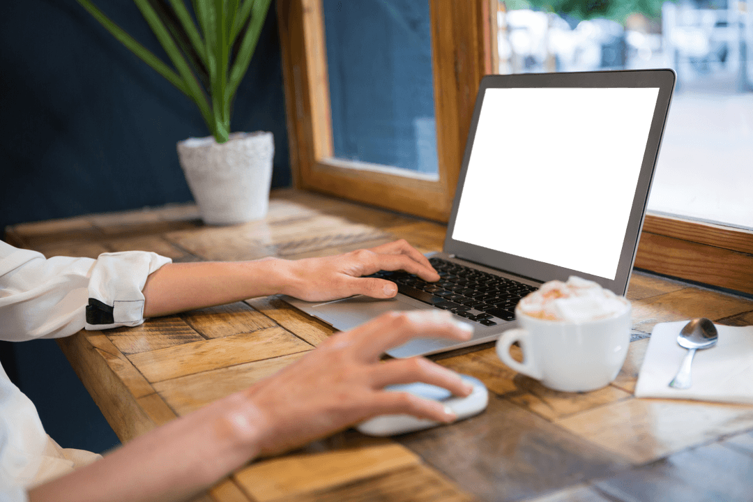 Woman Using Transparent Laptop at Cozy Cafe Table