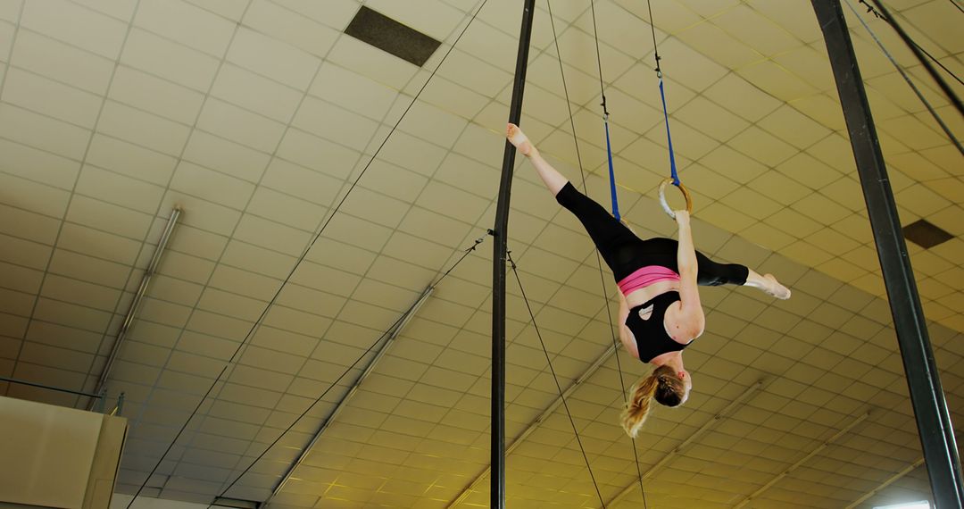 Woman Practicing Aerial Gymnastics on Hoops in Indoor Gym - Free Images, Stock Photos and Pictures on Pikwizard.com