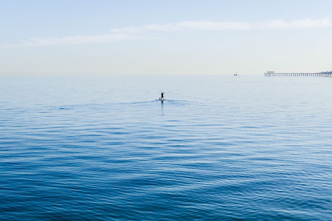 Peaceful Paddleboarding on Tranquil Blue Sea