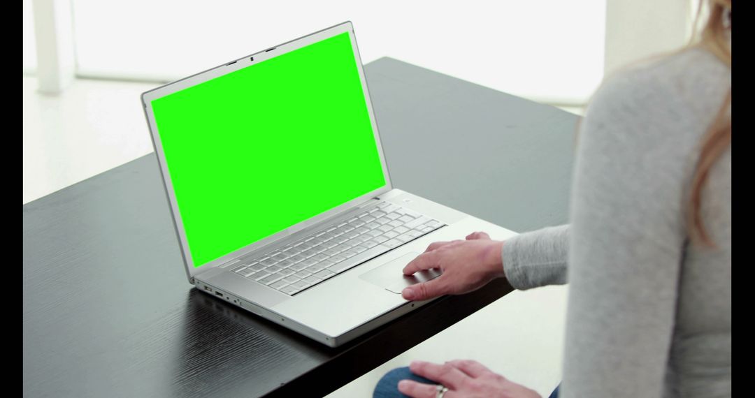 Woman Using Laptop with Green Screen on Wooden Desk - Free Images, Stock Photos and Pictures on Pikwizard.com