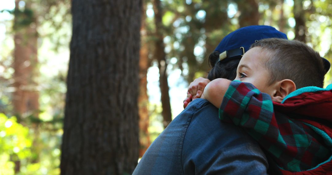 Father Carrying Son on Shoulder in Forest - Free Images, Stock Photos and Pictures on Pikwizard.com