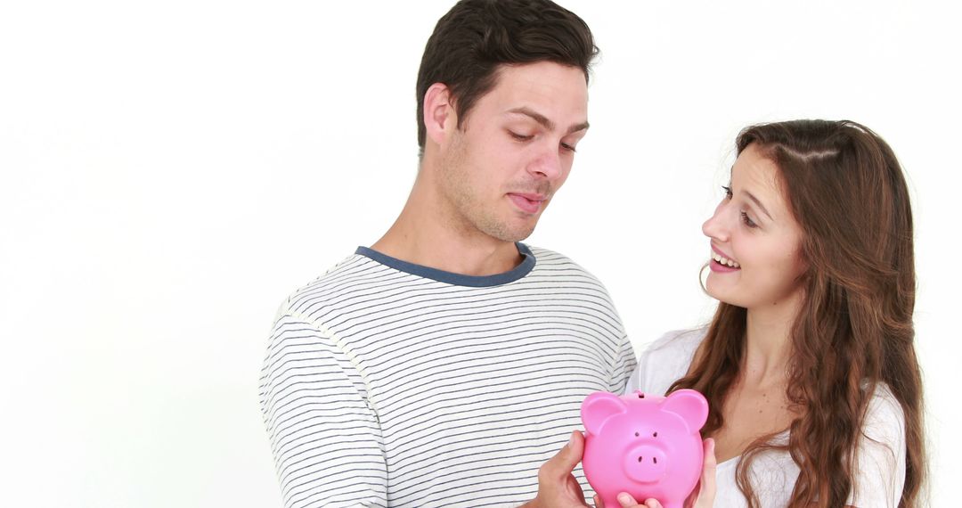 Young Couple Discussing Savings Holding Pink Piggy Bank - Free Images, Stock Photos and Pictures on Pikwizard.com