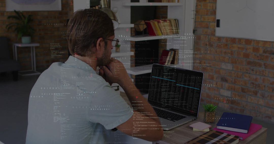 Developer analyzing code on laptop in modern home office with brick wall and notebooks