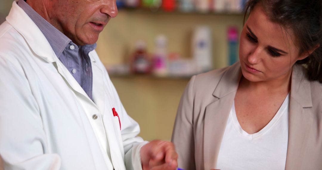 Pharmacist Advising Female Customer with Medicines in Pharmacy - Free Images, Stock Photos and Pictures on Pikwizard.com