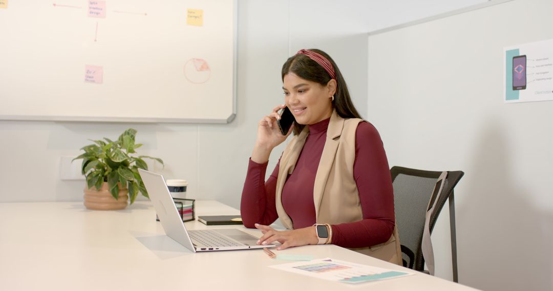 Businesswoman Communicating on Phone at Office Desk