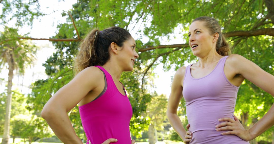 Two Women in Sportswear Talking in Park During Workout - Free Images, Stock Photos and Pictures on Pikwizard.com