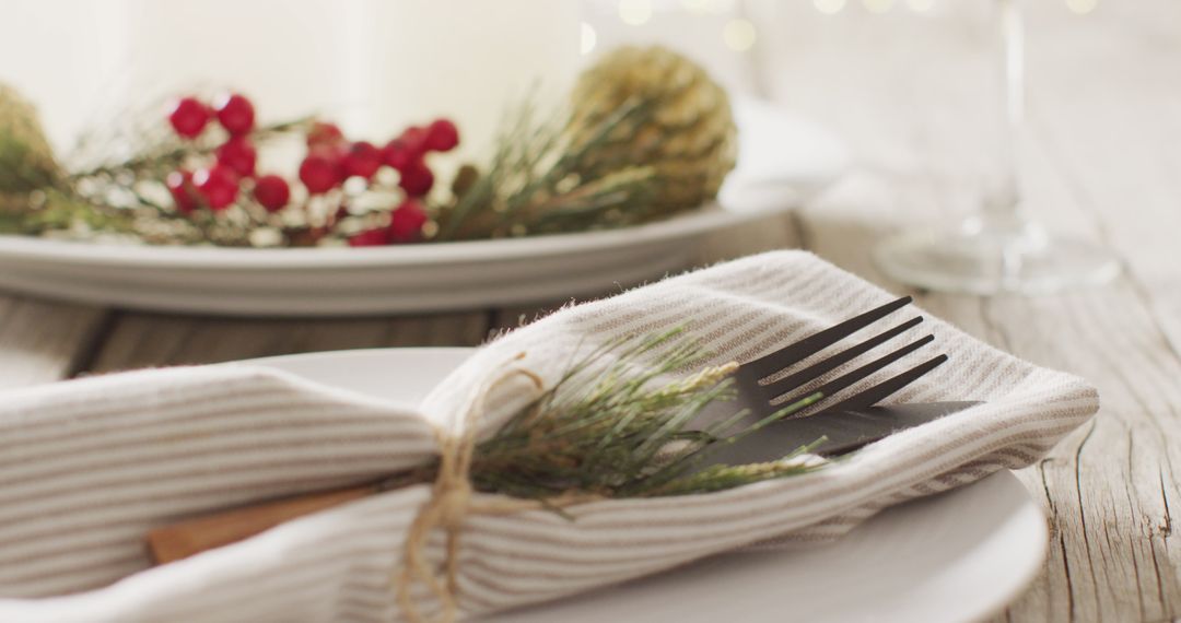 Festive Table Setting with Pine Décor and Berry Details
