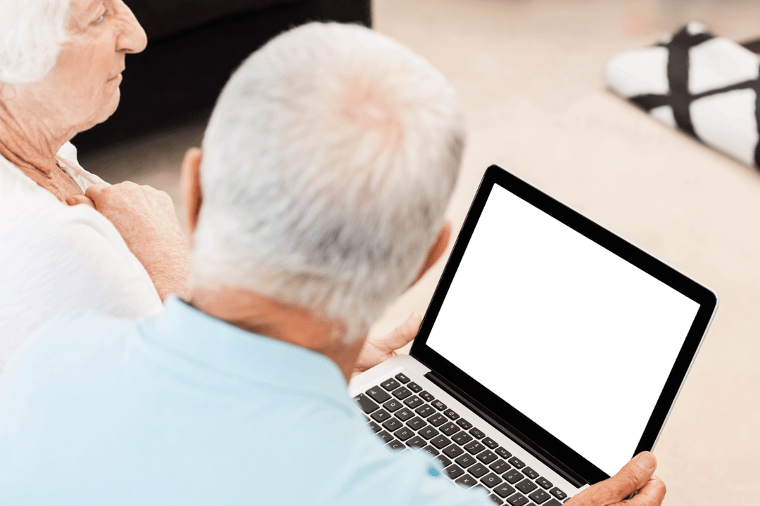 Elderly Couple Engaging with Technology Using Transparent Laptop Screen