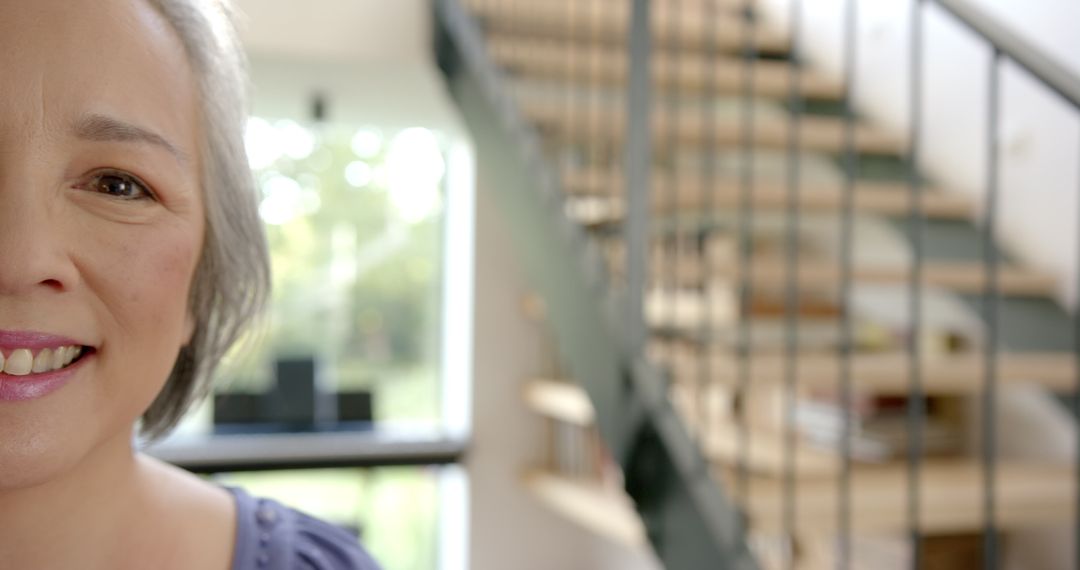 Elderly Asian Woman Smiling in Modern Home Interior