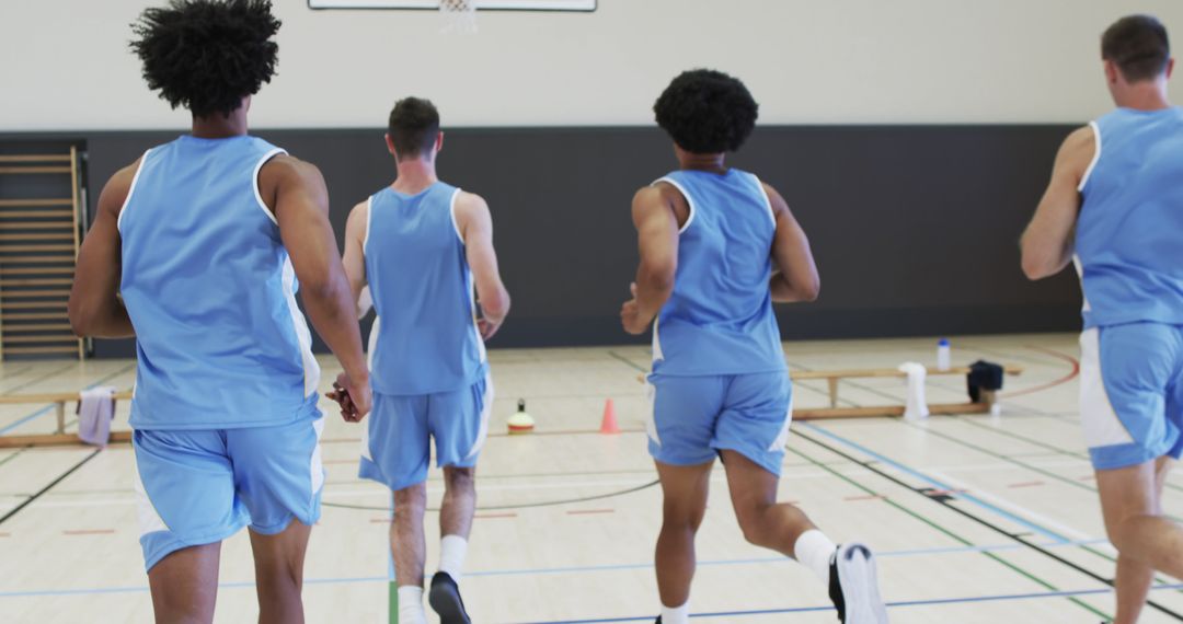 Basketball Players Running in Gym During Training Session - Free Images, Stock Photos and Pictures on Pikwizard.com